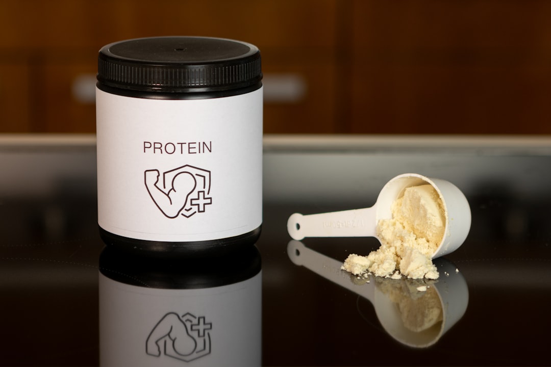 Vanilla protein supplement jar and scoop, muscle recovery and fitness. Protein powder setup for daily fitness routine. Sharing the supplements and gear I actually use → linktr.ee/alexsaks.inspiration